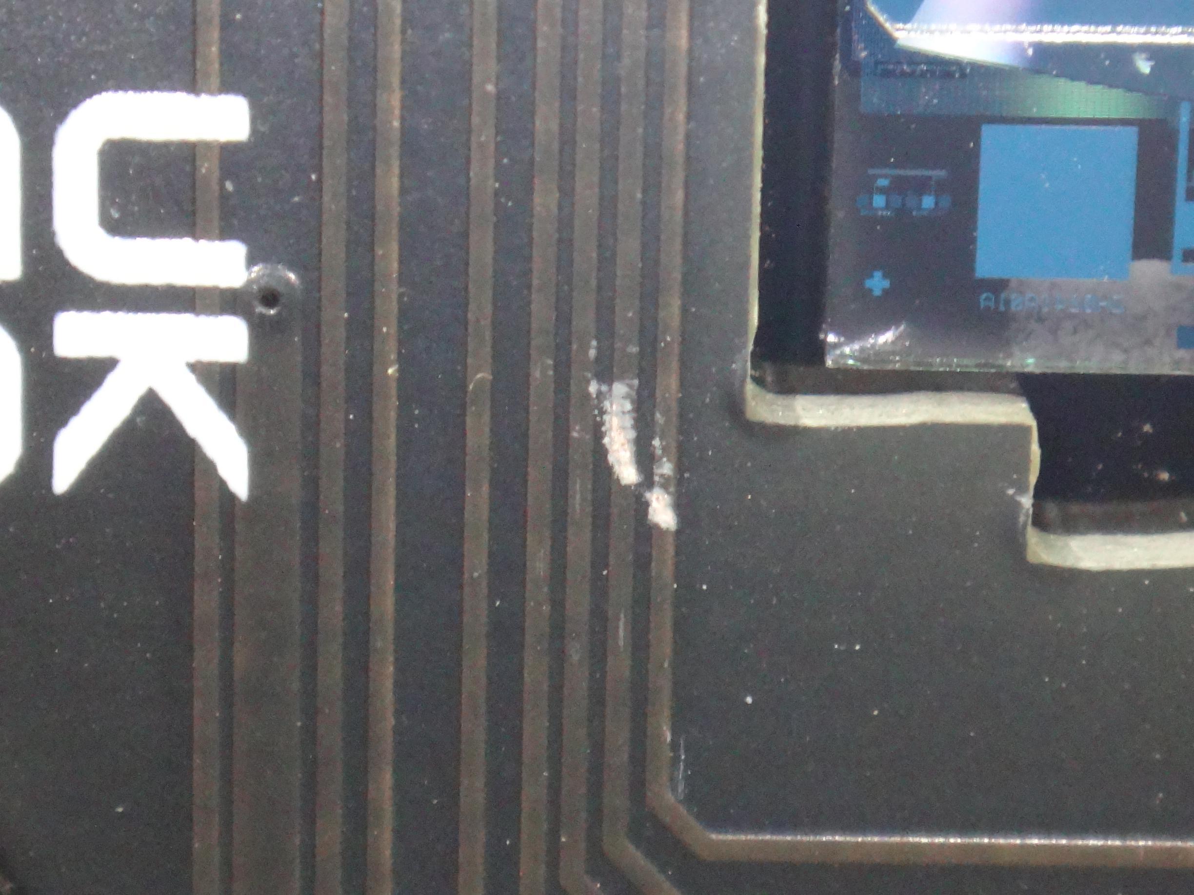 (two) scratches on the mainboard where the metal tube touches the pcb exposing the paths and possibly shortening them